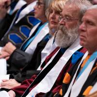 faculty sitting and watching the ceremony